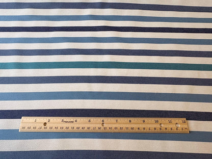Striped Seasonal Outdoor Fabric Pattern. Varying Shades of Blue Stripes. Teal Stripe, Navy Blue Stripe, and Columbia Blue Stripe Woven Fabric. Shop now at American Fabric Prints.