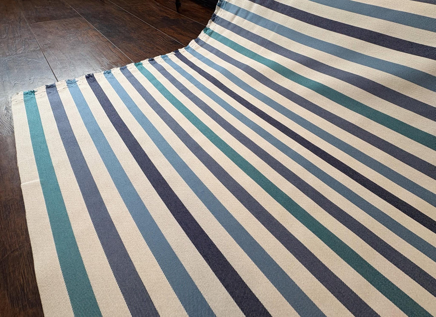 Striped Seasonal Outdoor Fabric Pattern. Varying Shades of Blue Stripes. Teal Stripe, Navy Blue Stripe, and Columbia Blue Stripe Woven Fabric. Shop now at American Fabric Prints.