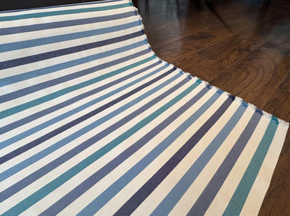 Striped Seasonal Outdoor Fabric Pattern. Varying Shades of Blue Stripes. Teal Stripe, Navy Blue Stripe, and Columbia Blue Stripe Woven Fabric. Shop now at American Fabric Prints.